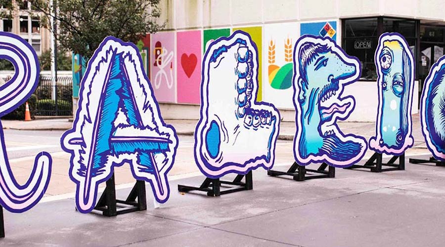 Photo of the word Raleigh in giant standup type with art painted on letters